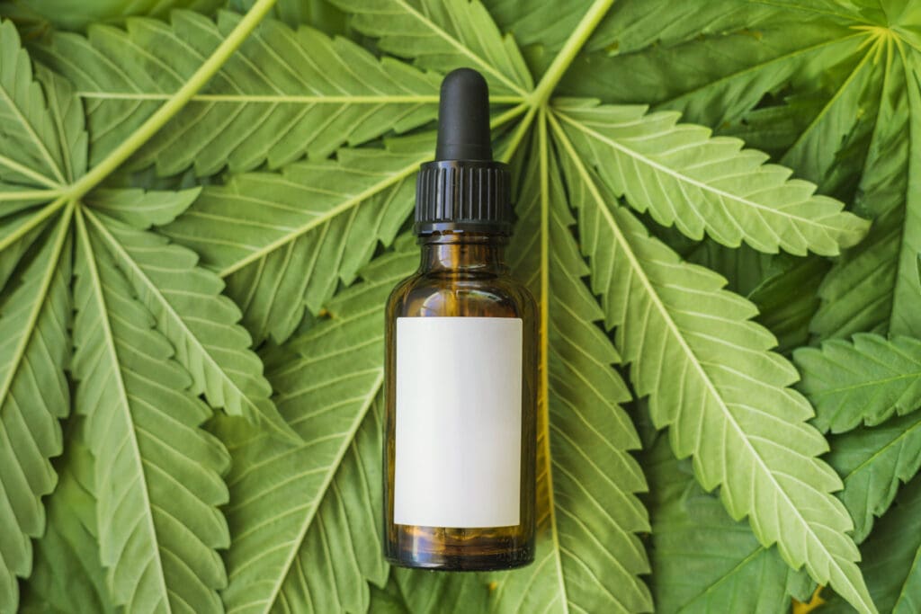 Private label THC tincture bottle on cannabis leaves for branding