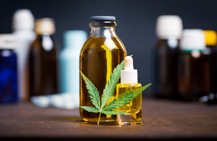 Cannabis oil bottles with marijuana leaf