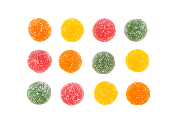 Colorful sugar-coated gummy candies arranged in rows