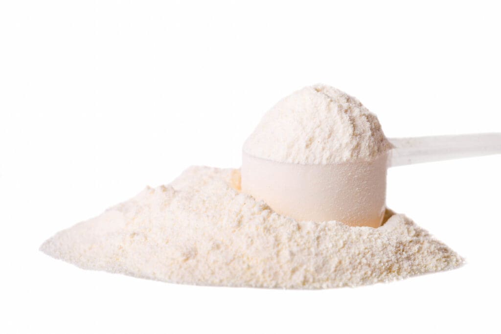 Scoop of protein powder on white background
