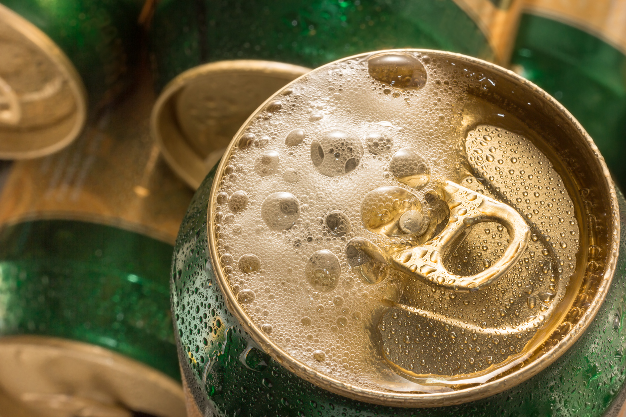 Close-up of a foamy soda can top.