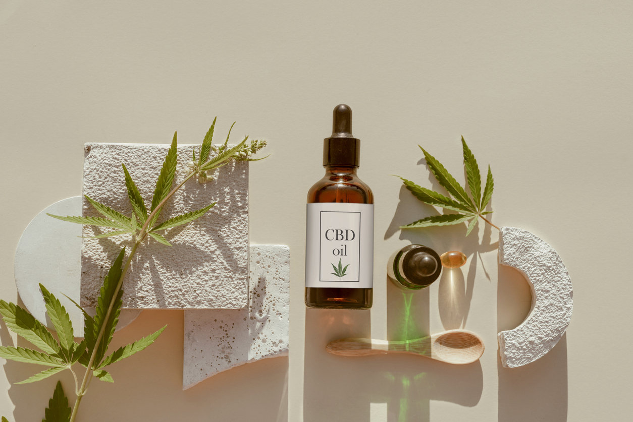 CBD oil bottle with hemp leaves and spoon