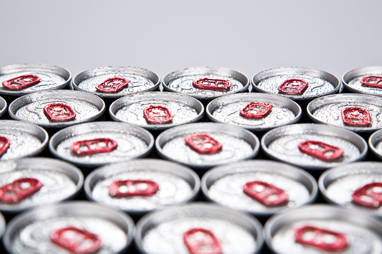 Close-up of opened soda can tops in rows